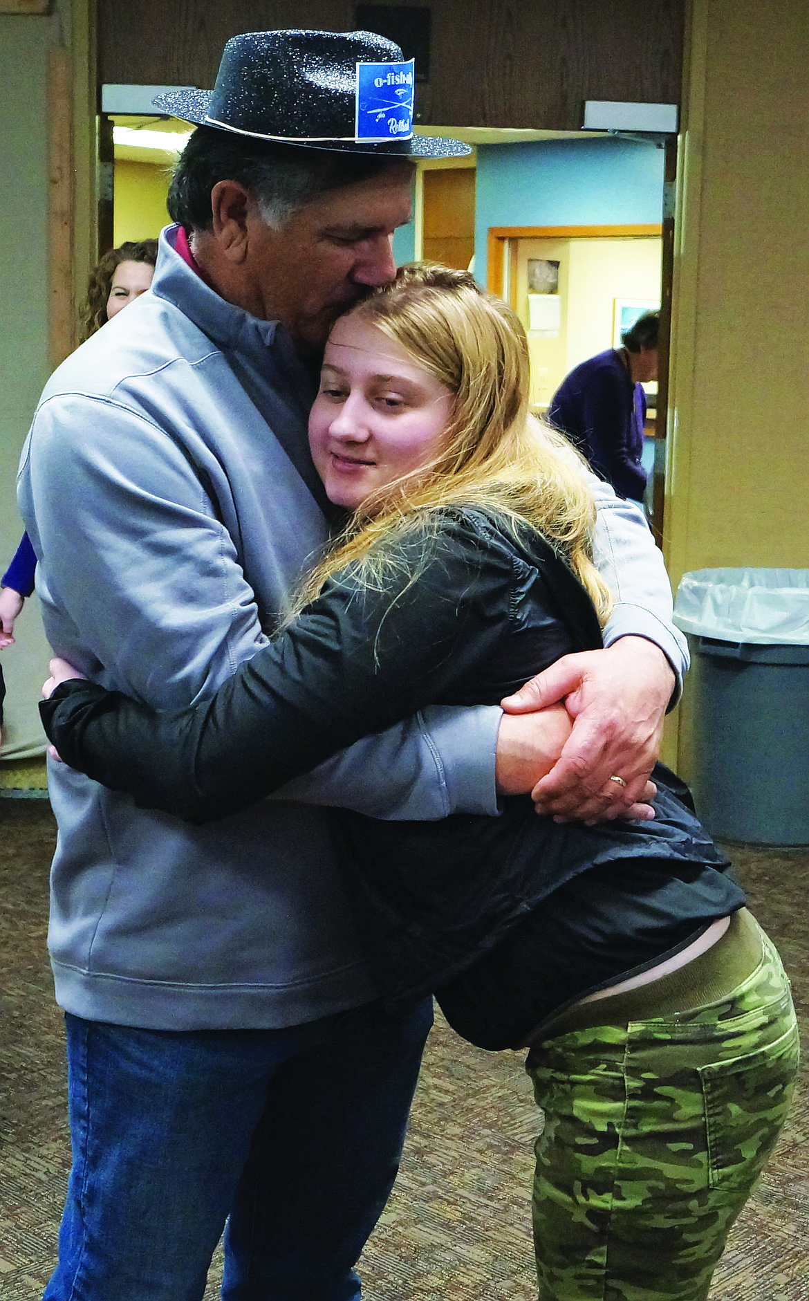 Retiring Parks Superintendent Rolando Gonzales reacts with surprise upon seeing Ashley Dieringer, now age 19,  the inspiration for the all-inclusive Ashley’s Playground in McCosh Park. Gonzales was honored during an open house retirement event Thursday at the Parks and Recreation Department. Gonzales worked on the playground project in 2005 with the help of Ashley’s mother Christi Dieringer.