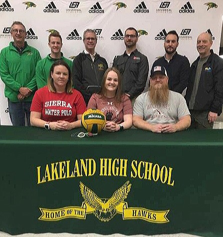 Courtesy photo 
 Lakeland High senior Hannah Dansereau recently signed a letter of intent to compete in water polo and swimming at Sierra (community) College in Rocklin, Calif. Seated from left are Michelle Dansereau (mom); Hannah Dansereau and Steve Dansereau (dad); and standing from left, Rob Urbaniak, Lakeland High head swimming coach; Adam Mayer, Lakeland assistant swimming coach; Mike Divilbiss, Lakeland athletic director; Gary Kessie, Kroc aquatics manager; Brady Hooper, Coeur d'Alene/Kroc assistant water polo coach; and Mark Collingham- Cd'A/Kroc head water polo coach.