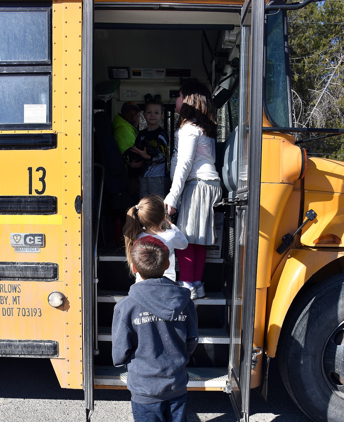 Children board a school bus March 18 to receive breakfast and lunch meals from staff with Libby Public Schools District. (Duncan Adams/The Western News)