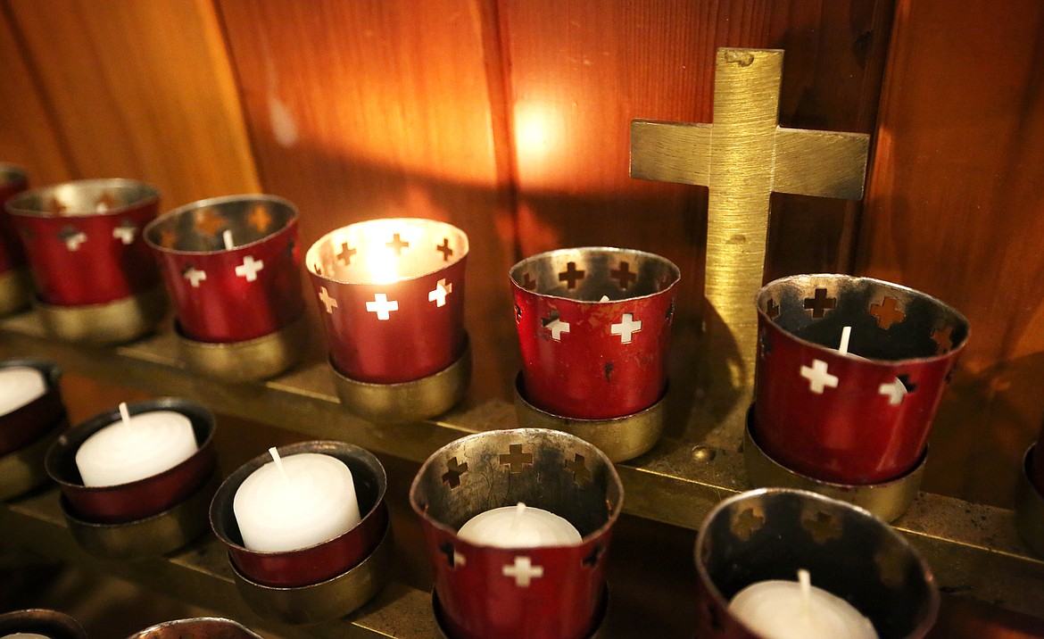 A single candle is illuminated inside Saint Richard Church in Columbia Falls.