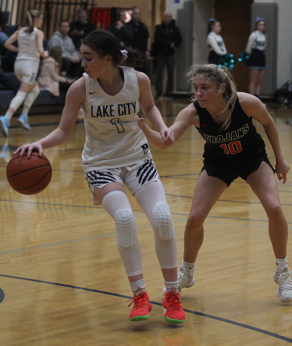 Lake City senior Aubrey Avery dribbles away from Post Falls junior Dylan Lovett during the 5A Region 1 second-place game on Feb. 15 in Coeur d’Alene.