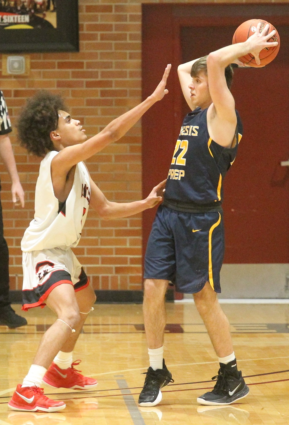 Vander Brown, left, of Lakeside guards Nathan Weeks of Genesis Prep in the 1A Division II District 1 championship game Feb. 27 at North Idaho College.