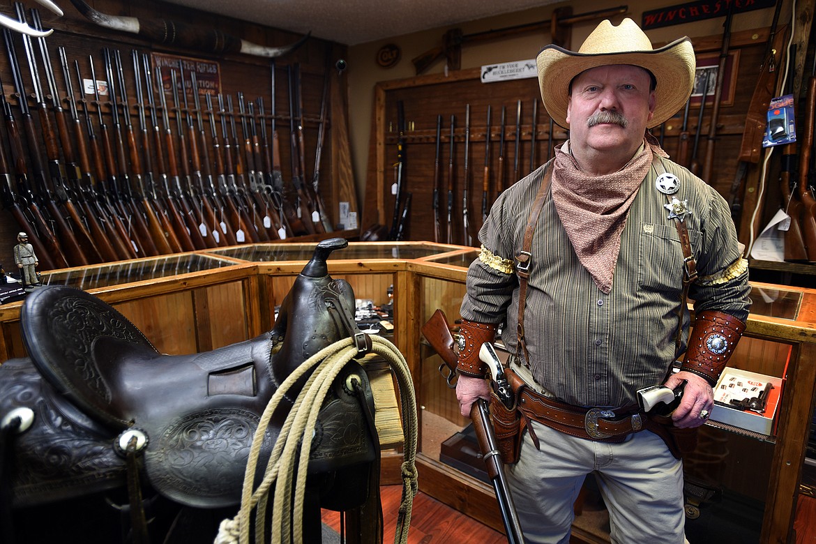 Richard Cheney, owner of Short Colt Antique Arms in Bigfork, shows off the outfit he wore as a cowboy action shooter for 16 years. (Jeremy Weber/Bigfork Eagle)