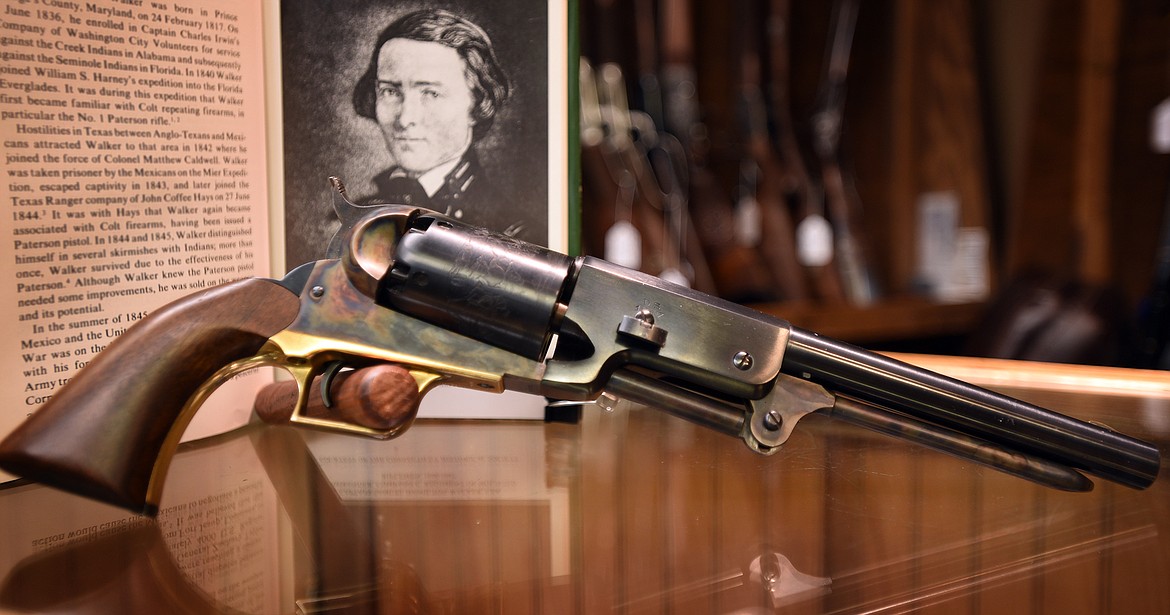 A replica of the 1847 Walker Colt revolver rests in front of a photo of designer Captain Samuel Hamilton Walker. (Jeremy Weber/Bigfork Eagle)