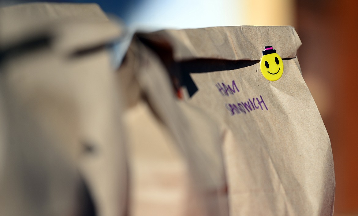 A grab-and-go meal is sealed with a smiley face sticker outside Bigfork ACES on Wednesday, March 18.