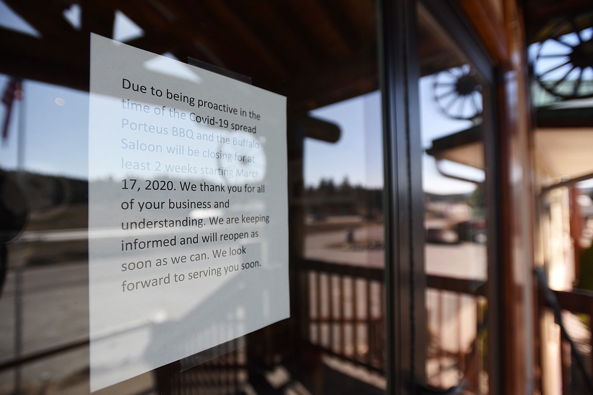 A sign posted on the door of Porteus BBQ in Bigfork regarding their operations during the coronavirus pandemic on Wednesday, March 18. (Casey Kreider/Daily Inter Lake)