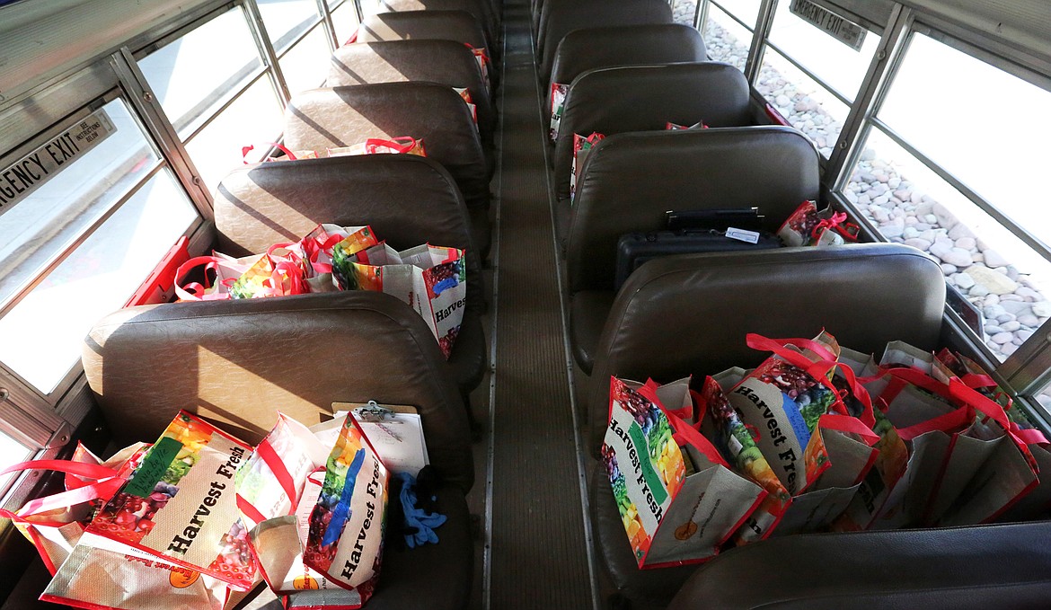 Bags of school supplies fill seats in Bus 18. Parents used an online form to request items like books, meals and instruments.