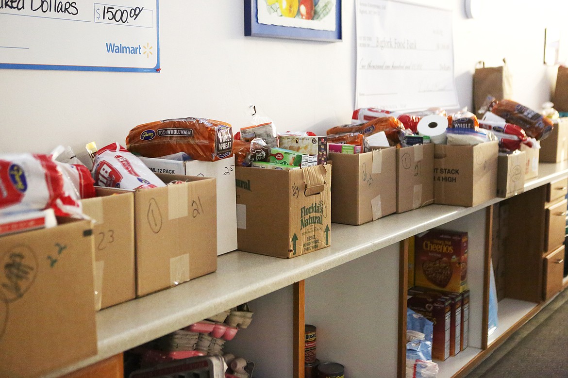 Pre-packaged boxes of food based on family size fill counters at Bigfork Food Bank on Monday morning. (Mackenzie Reiss/Bigfork Eagle)