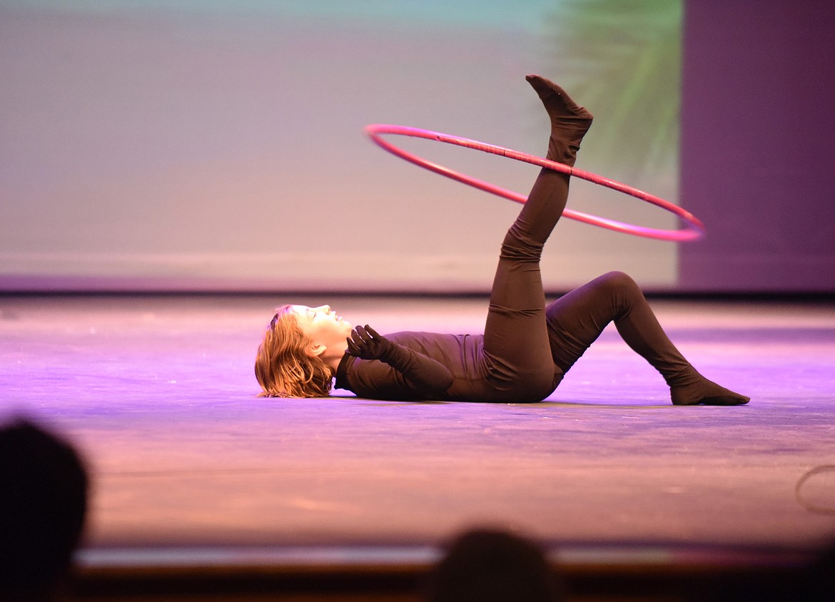 Ayslin Johnson does tricks with a hula hoop during the Whitefish Middle School talent show earlier this month at the Whitefish Performing Arts Center. (Heidi Desch/Whitefish Pilot)