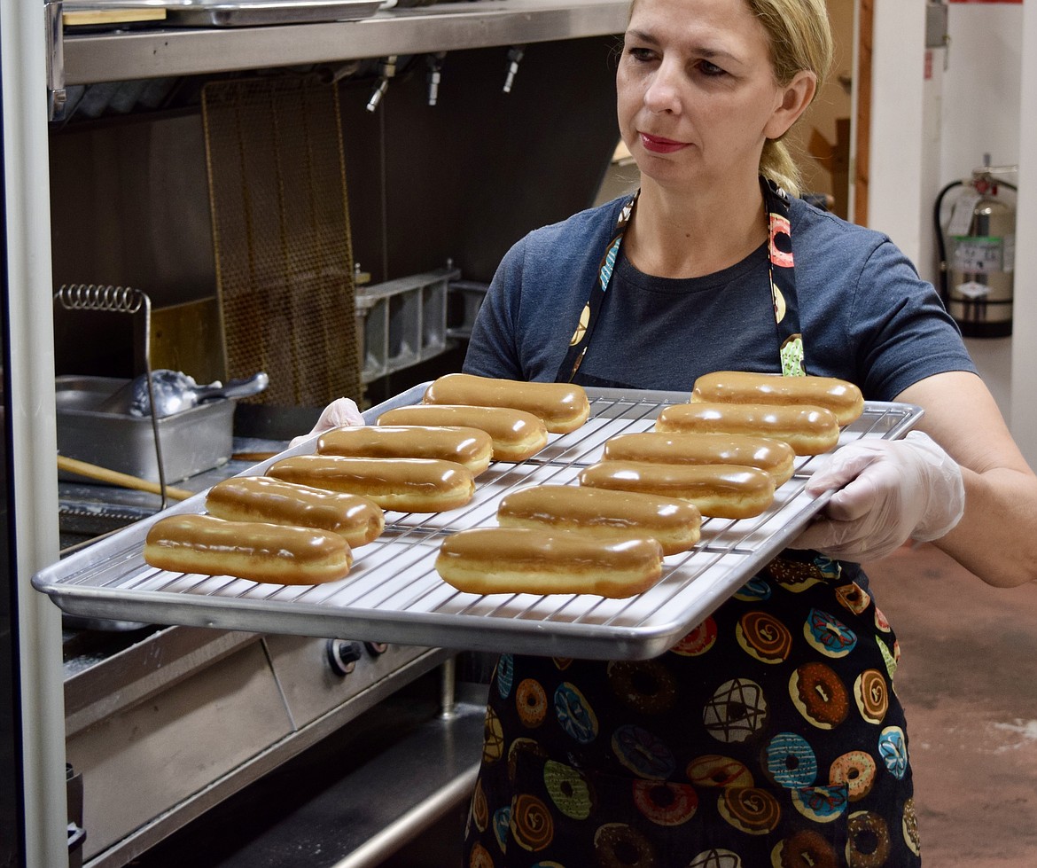 Lisa Boorman, co-owner of Red Door Cafe, with a tray of maple bars.