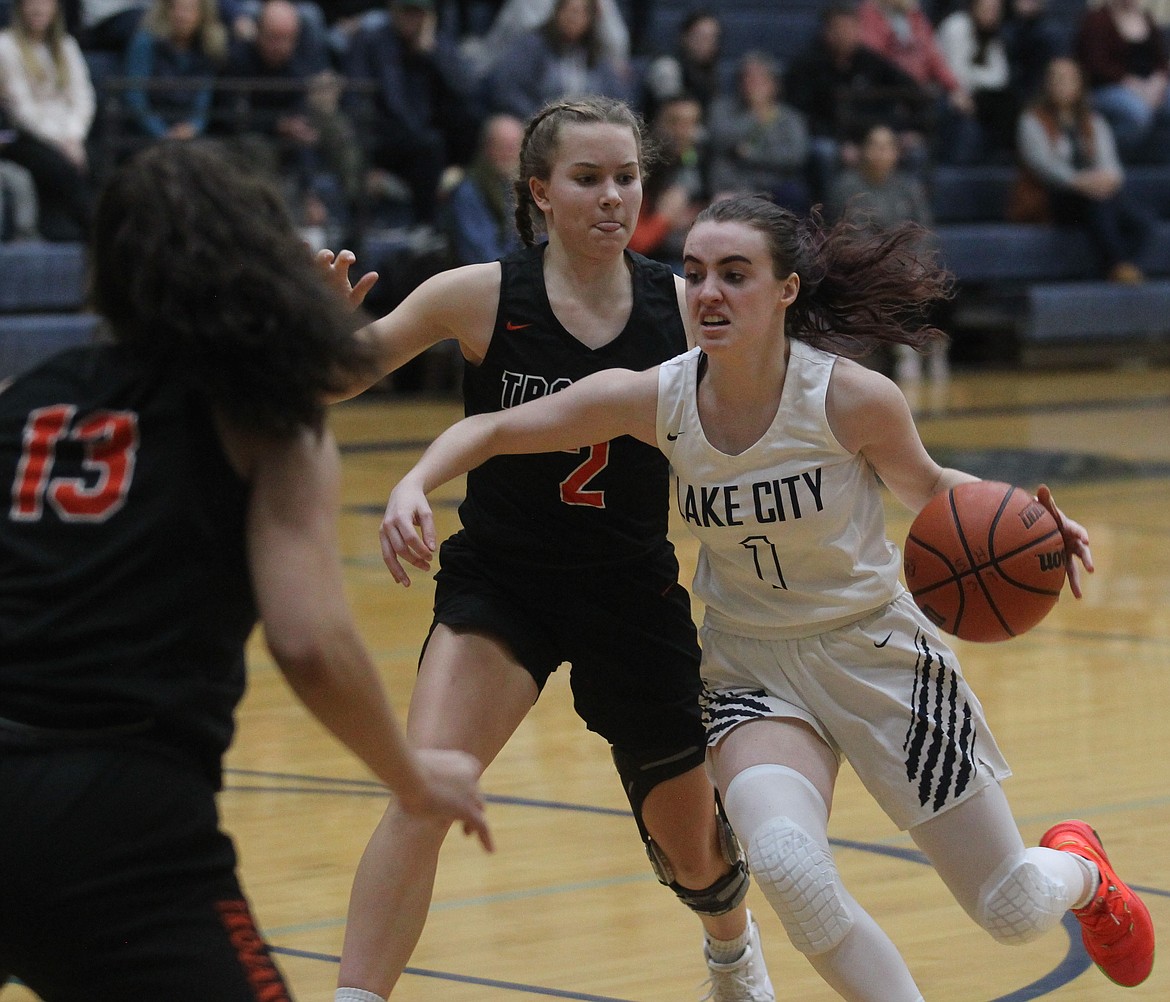 Lake City senior guard Aubrey Avery drives past Post Falls sophomore Lexie Heath during the 5A Region 1 second-place game on Feb. 15 at Lake City High. Avery has signed with NAIA Park University in Gilbert, Ariz.