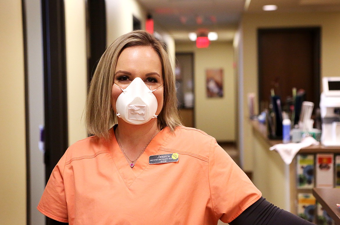 Jessica Valentine, a scribe and certified opthalmic technician, wears an N95 mask made by a 3D printer during her shift at Glacier Eye Clinic. (Mackenzie Reiss/Daily Inter Lake)
