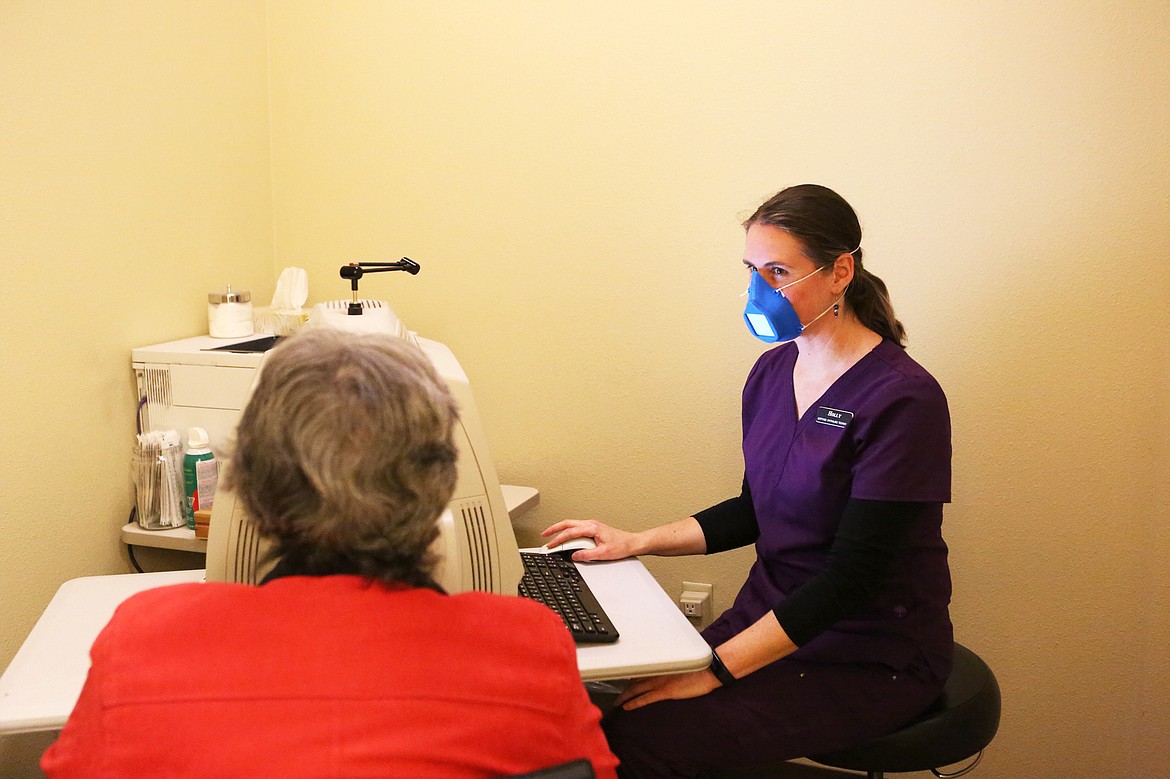 Holly Spangler, a certified ophthalmic technician at Glacier Eye Clinic, uses an N95 mask during an interaction with a patient. (Mackenzie Reiss/Daily Inter Lake)
