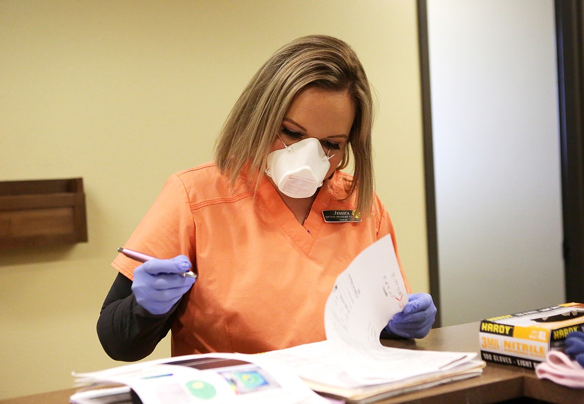 Jessica Valentine, a scribe and certified opthalmic technician, wears an N95 mask made by a 3-D printer during her shift at Glacier Eye Clinic. (Mackenzie Reiss/Daily Inter Lake)