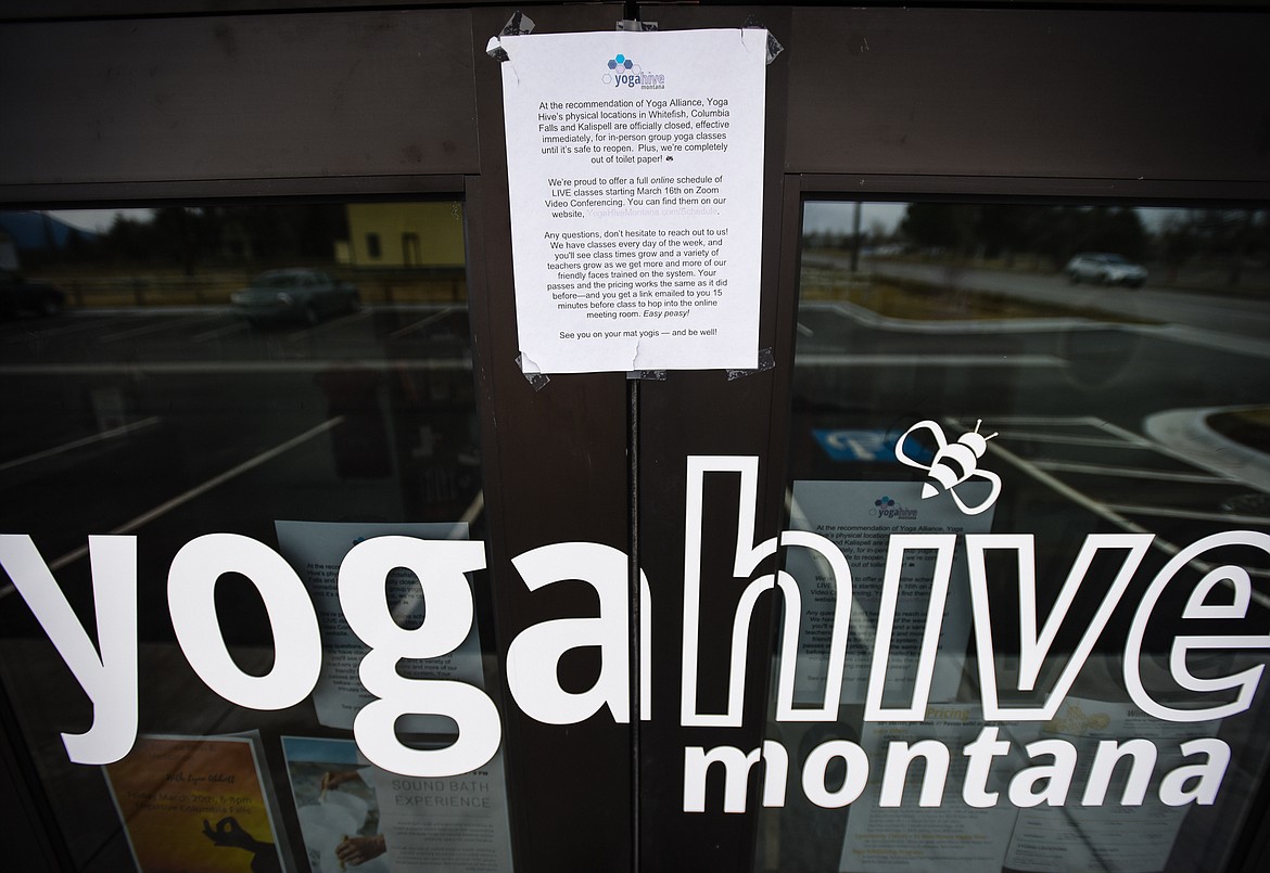 A sign at the entrance to the Yoga Hive Montana studio in Kalispell advertises their online schedule of classes utilizing Zoom video conferencing technology on March 31. (Casey Kreider/Daily Inter Lake)
