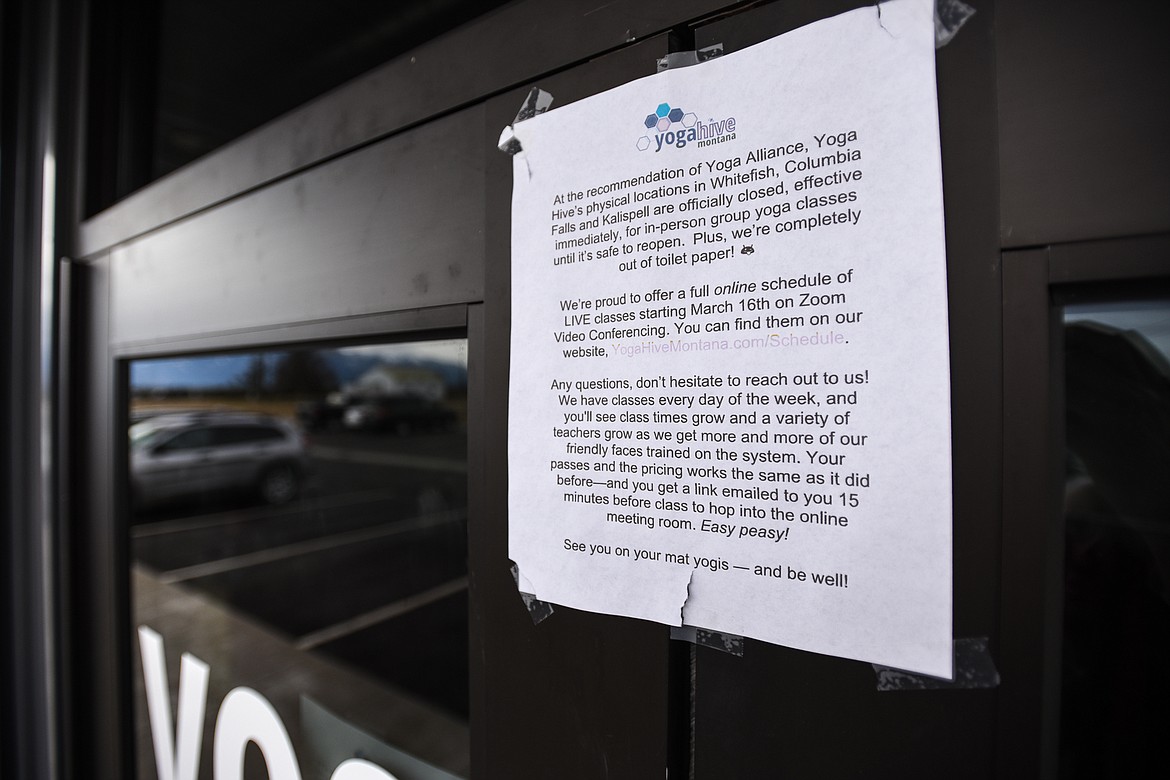 A sign at the entrance to the Yoga Hive Montana studio in Kalispell advertises their online schedule of classes utilizing Zoom video conferencing technology on Tuesday, March 31. (Casey Kreider/Daily Inter Lake)