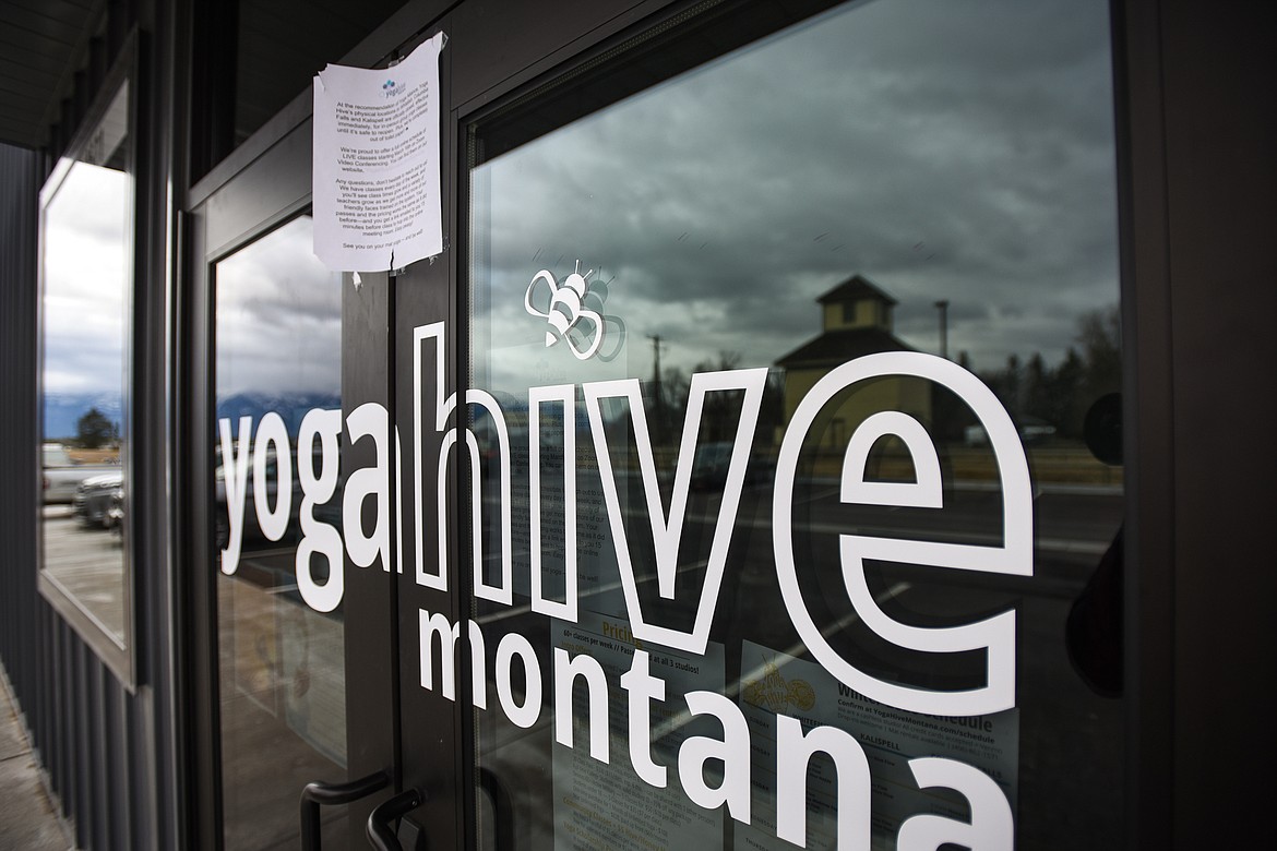 A sign at the entrance to the Yoga Hive Montana studio in Kalispell advertising their online schedule of classes utilizing Zoom video conferencing technology on Tuesday, March 31. (Casey Kreider/Daily Inter Lake)
