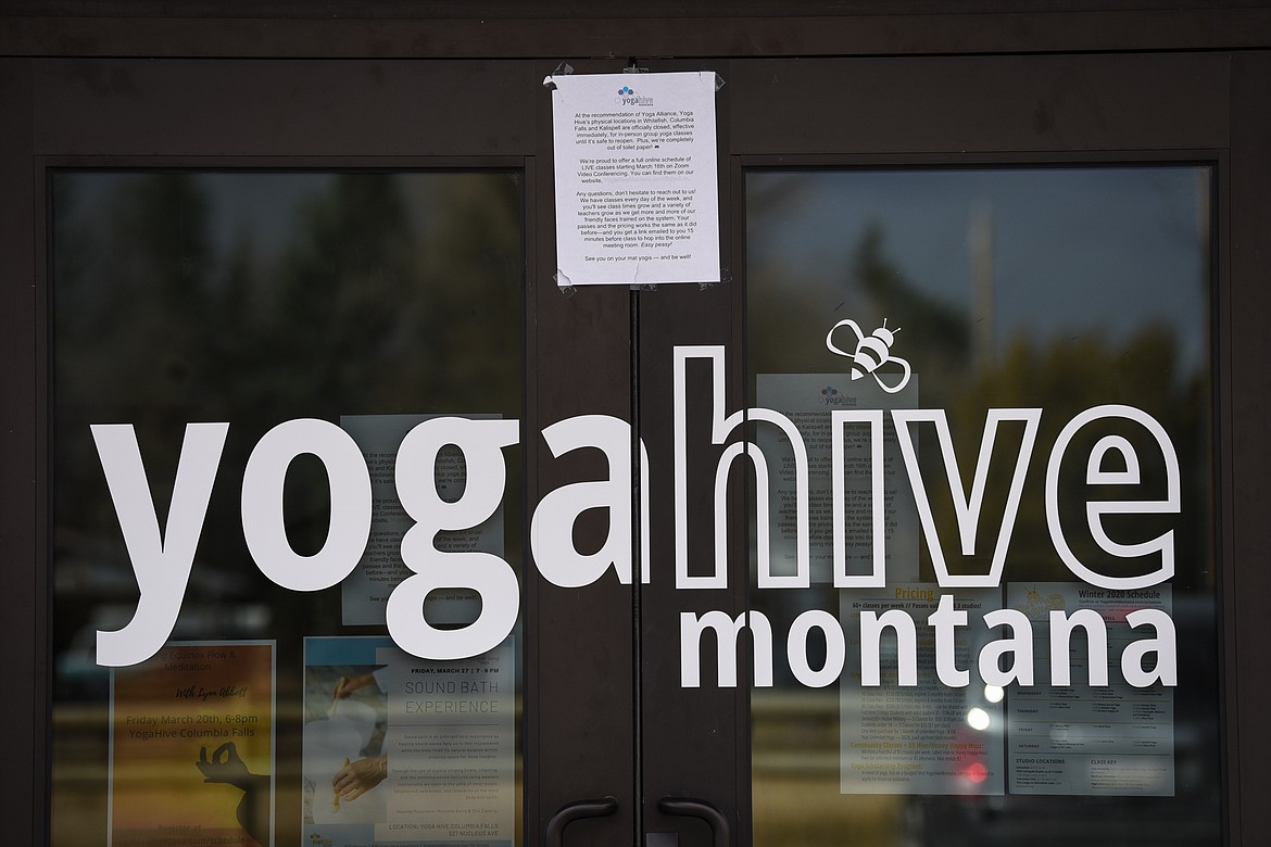 A sign at the entrance to the Yoga Hive Montana studio in Kalispell advertises their online schedule of classes utilizing Zoom video conferencing technology on Tuesday, March 31. (Casey Kreider/Daily Inter Lake)