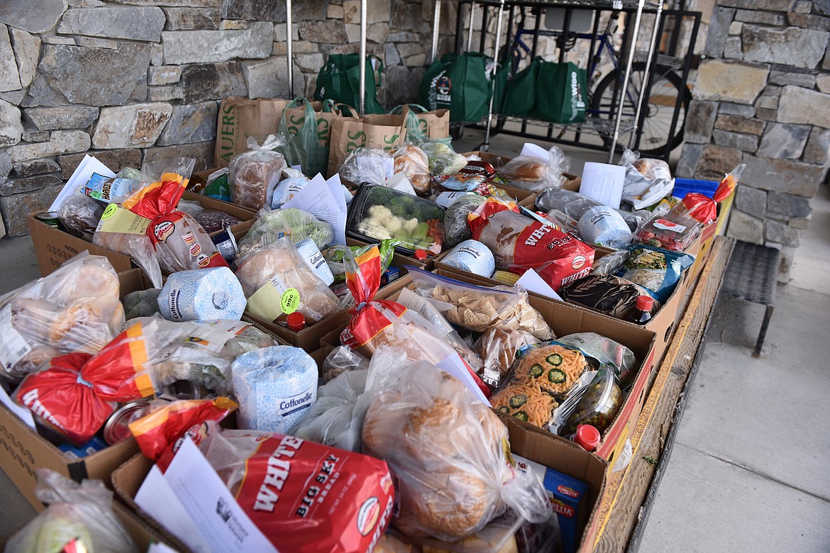 Boxes of food sit outside North Valley Food Bank waiting to be distributed. (Heidi Desch/Whitefish Pilot)