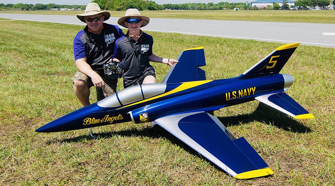 Josh Clark, right, and his father Addison Clark III show off Josh’s F-18 model painted in the colors of the Blue Angels. (Photo provided)