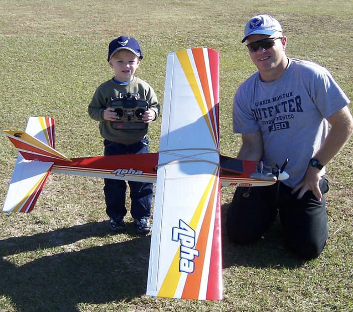 A young Josh Clark (left) and his father, Addison Clark III, show off one of their prop models. (Photo provided)