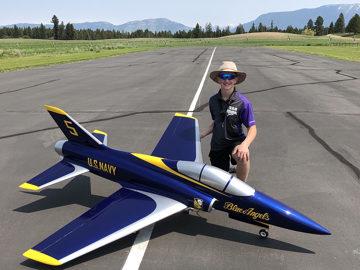 Josh Clark shows off Josh’s F-18 model painted in the colors of the Blue Angels. (Photo provided)