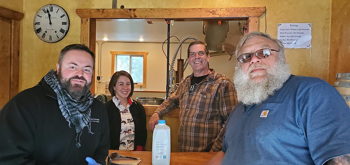 Local residents are pitching in to help with the fight against COVID-19 From left are Sam Redfern, president of United States of Hope, Christina and Carl Bock from Steel Toe Distillery, and David Williams, President of Joint Operation Mariposa. They teamed up to make hand sanitizer for first responders in Mineral, Sanders and Missoula counties. (Photo courtesy David Williams)