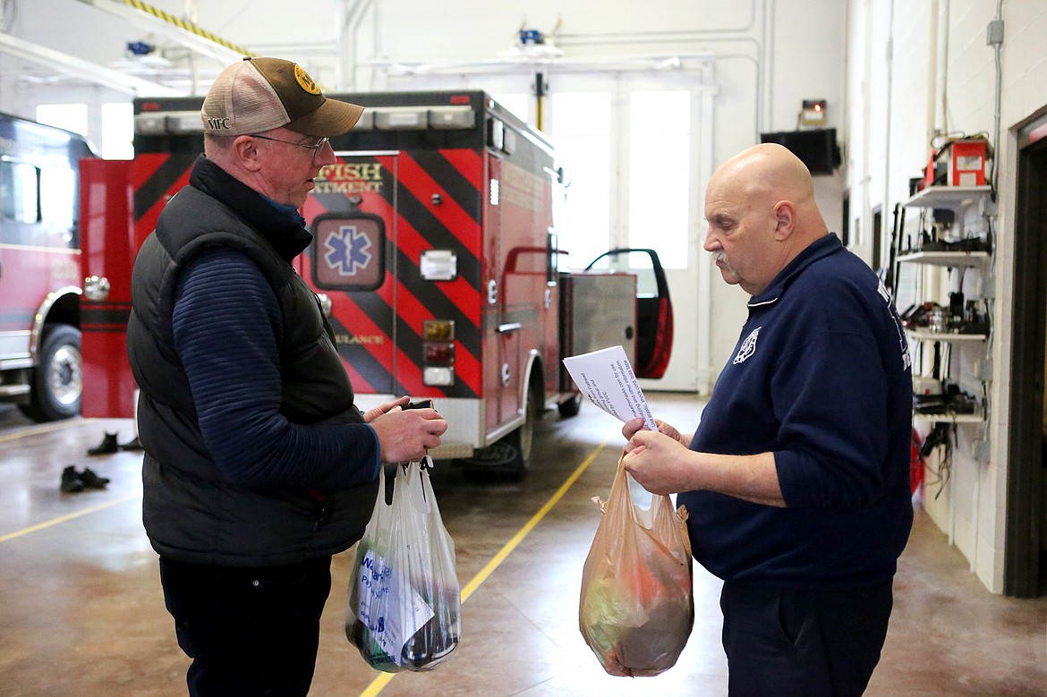 Whitefish High School chemistry teacher Todd Spangler drops off 30 Montana Masks to Whitefish Fire Chief Joe Page. (Mackenzie Reiss/Daily Inter Lake)