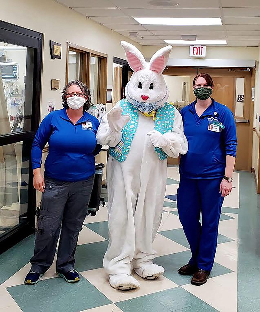 Two Clark Fork Valley Hospital employees, Sara Nestor, left, and Rashell Jones, right, flank the Easter Bunny, also known as Steve Spurr, during his visit on Easter Sunday. (Photo courtesy Whitney Tanner-Spurr)