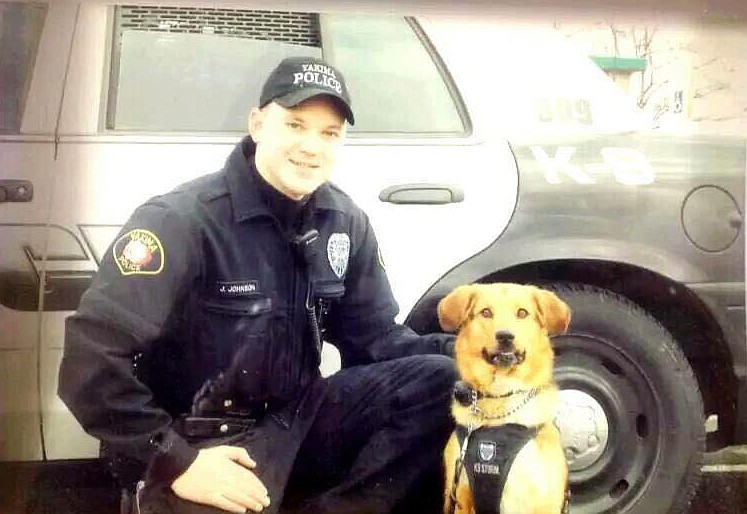 Jason Johnson, left, and Flash, right, pose in uniform for a picture with the Yakima Police Department in 2005.