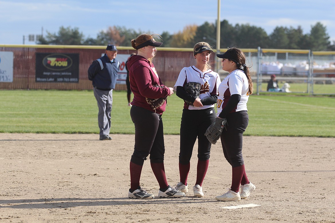 Casey McCarthy/Columbia Basin Herald Hadleigh Cranston, left, Gina Skinner, center, and Riley Sanchez chat during a break in play during a slowpitch softball game last fall.