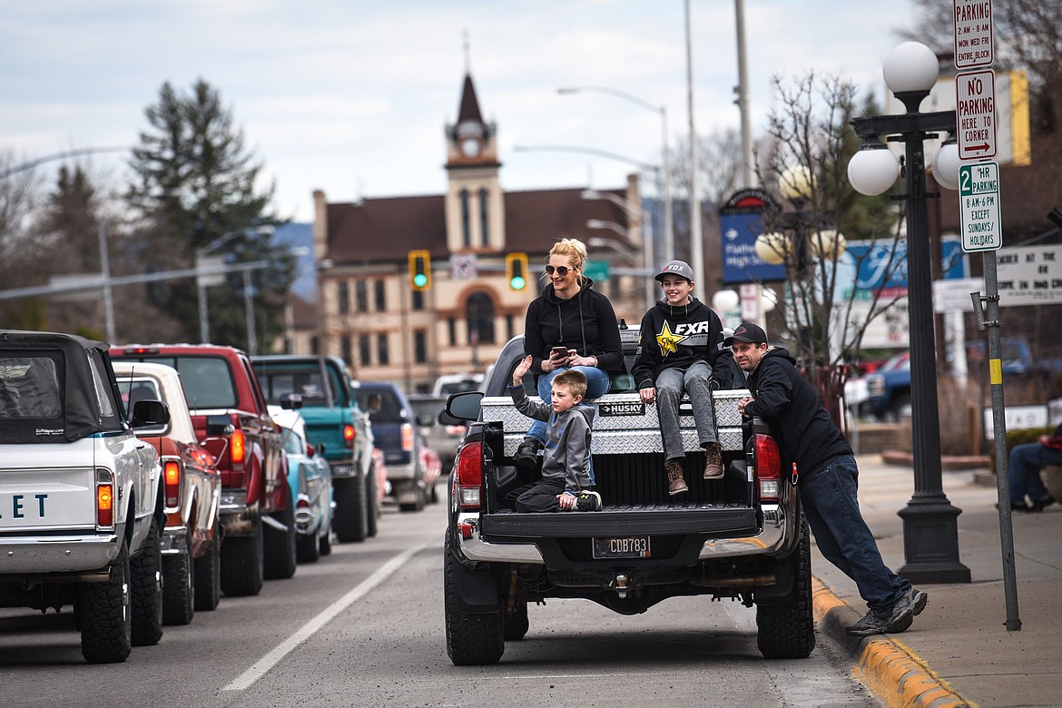 A family watches as cars and trucks make their way down Main Street during a Kruise Kalispell event on Friday, April 17. (Casey Kreider/Daily Inter Lake)