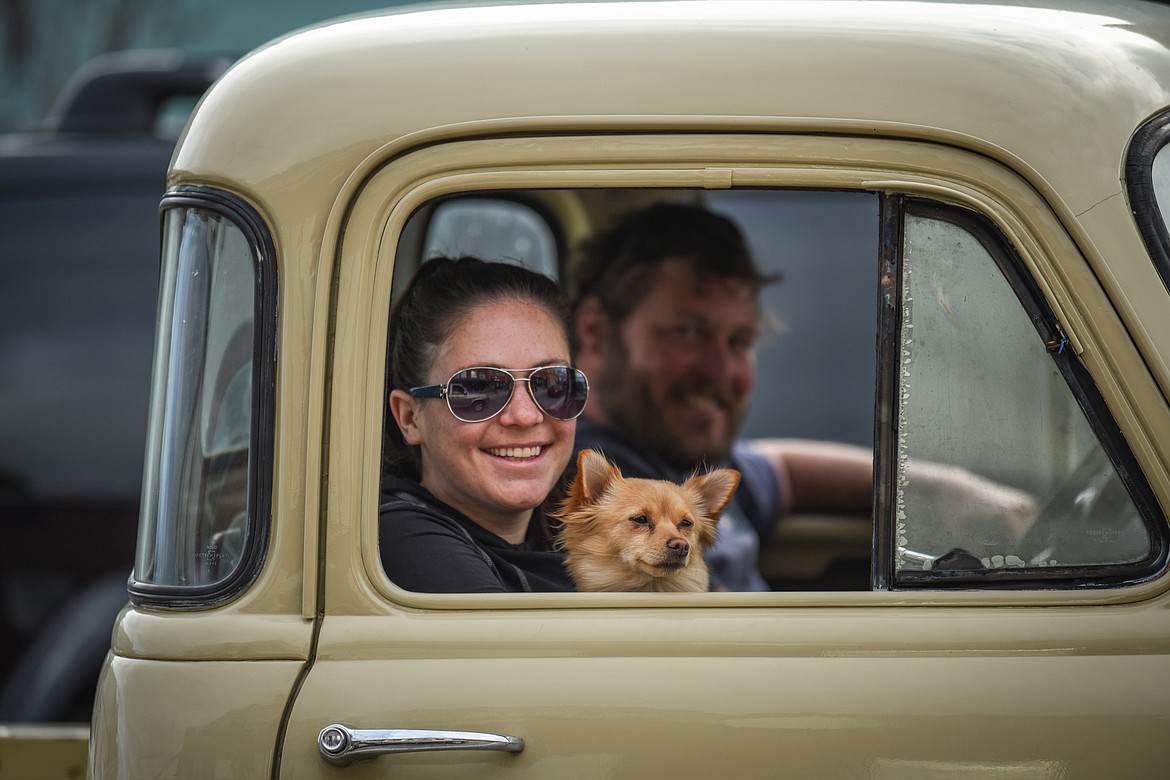 Passengers in a classic truck smile as they drive through the Kruise Kalispell event on Main Street on Friday, April 17. (Casey Kreider/Daily Inter Lake)