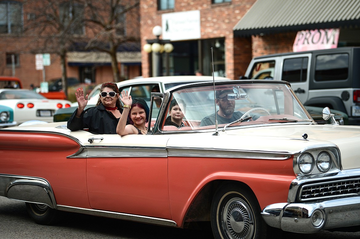 Passengers in a classic Ford wave as they drive through the Kruise Kalispell event on Main Street on Friday, April 17. (Casey Kreider/Daily Inter Lake)