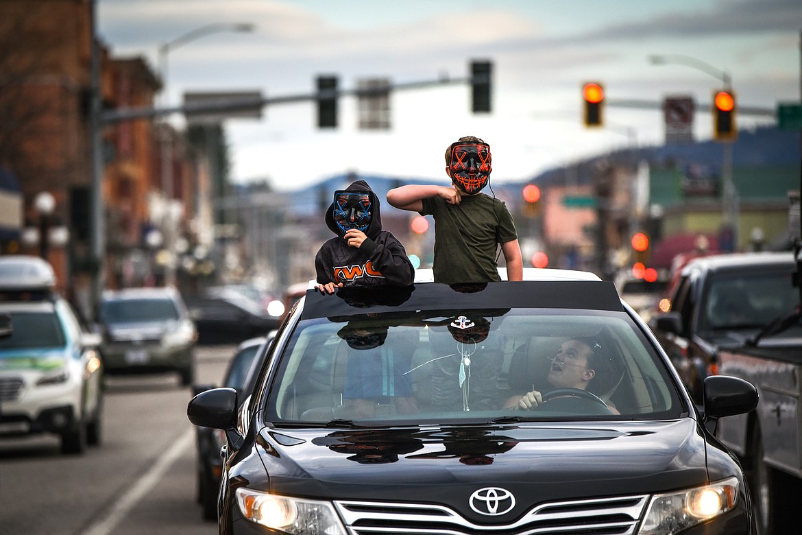 Two kids dance and wave out of a vehicle’s moonroof during the Kruise Kalispell event on Main Street on Friday, April 17. (Casey Kreider/Daily Inter Lake)