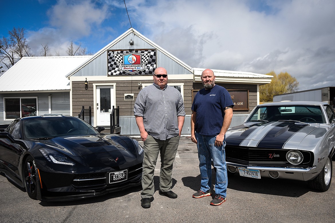 Monte Klindt, left, with his 2015 Chevrolet Corvette Stingray, and Jeremy Reese, right, with his 1969 Chevrolet Camaro Z28, outside the business they co-own, Performance Heating & Air in Evergreen on Thursday, April 23.