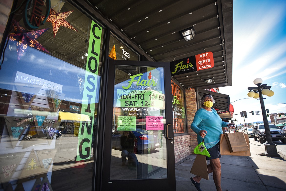 A shopper exits Flair Gifts & Cards in downtown Kalispell as it holds a going-out-of-business sale on Tuesday, April 28. (Casey Kreider/Daily Inter Lake)