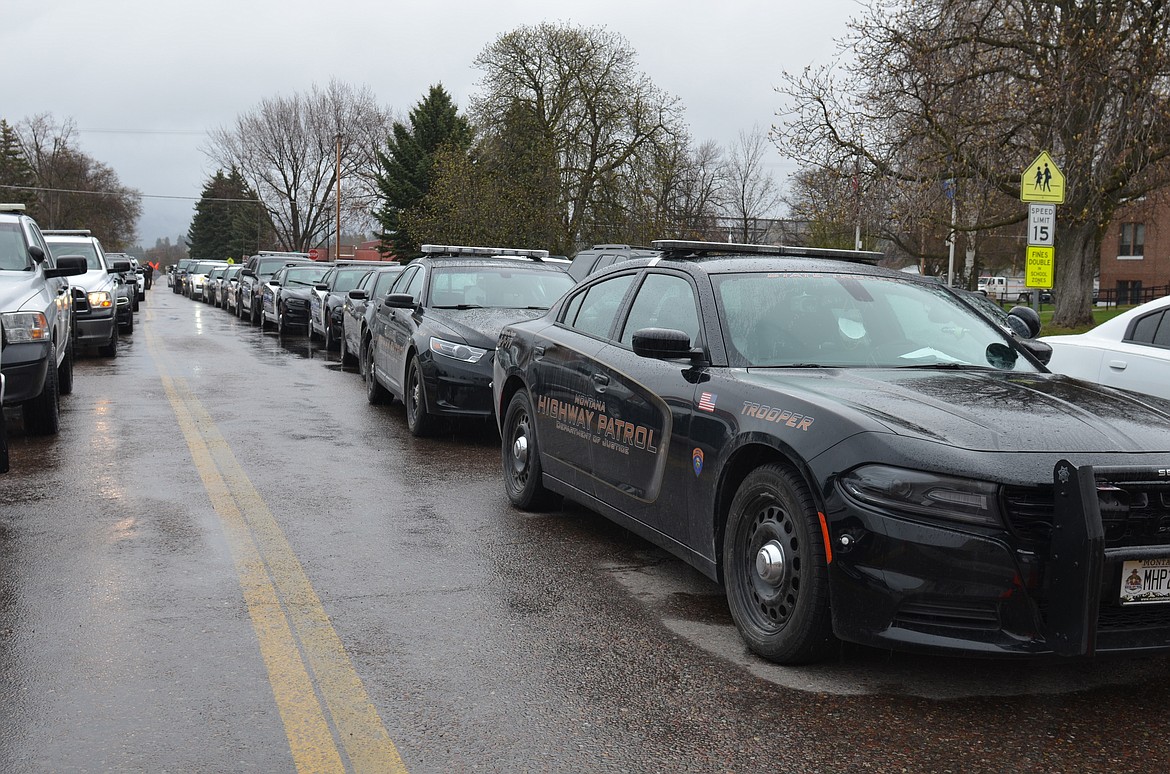 Law enforcement personnel from across the state join in a memorial procession on April 23 for Lake County Sheriff's Office Deputy Ross Holcomb, who died April 3 at his home in Ronan. Services were held after the procession via live stream from New Life Church in Polson. A burial with military honors will be held at the Bigfork Community Cemetery this summer. Deputy Holcomb had served with the Lake County Sheriff’s Department since 2017. (Emily Lonnevik/Lake County Leader)