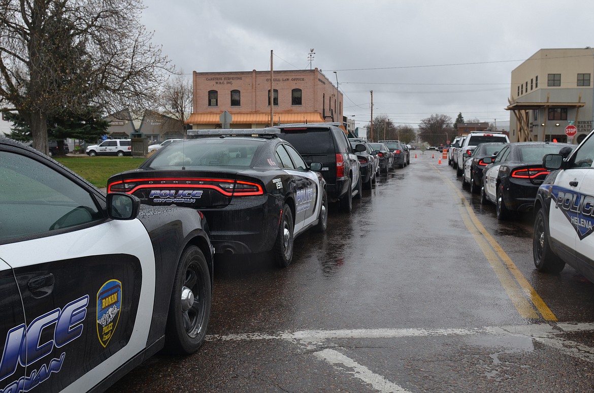 Law enforcement personnel from across the state join in a memorial procession on April 23 for Lake County Sheriff's Office Deputy Ross Holcomb, who died April 3 at his home in Ronan. Services were held after the procession via live stream from New Life Church in Polson. A burial with military honors will be held at the Bigfork Community Cemetery this summer. Deputy Holcomb had served with the Lake County Sheriff’s Department since 2017. (Emily Lonnevik/Lake County Leader)