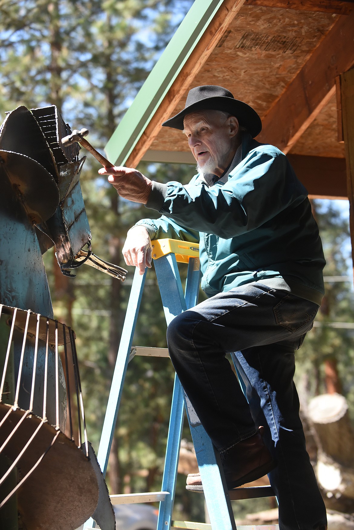 Plains artist Kenton Pies tinkers with a metal horse he is building. Pies has built two horses that are displayed in downtown Plains and he has plans for more. (Scott Shindledecker photos/Daily Inter Lake)