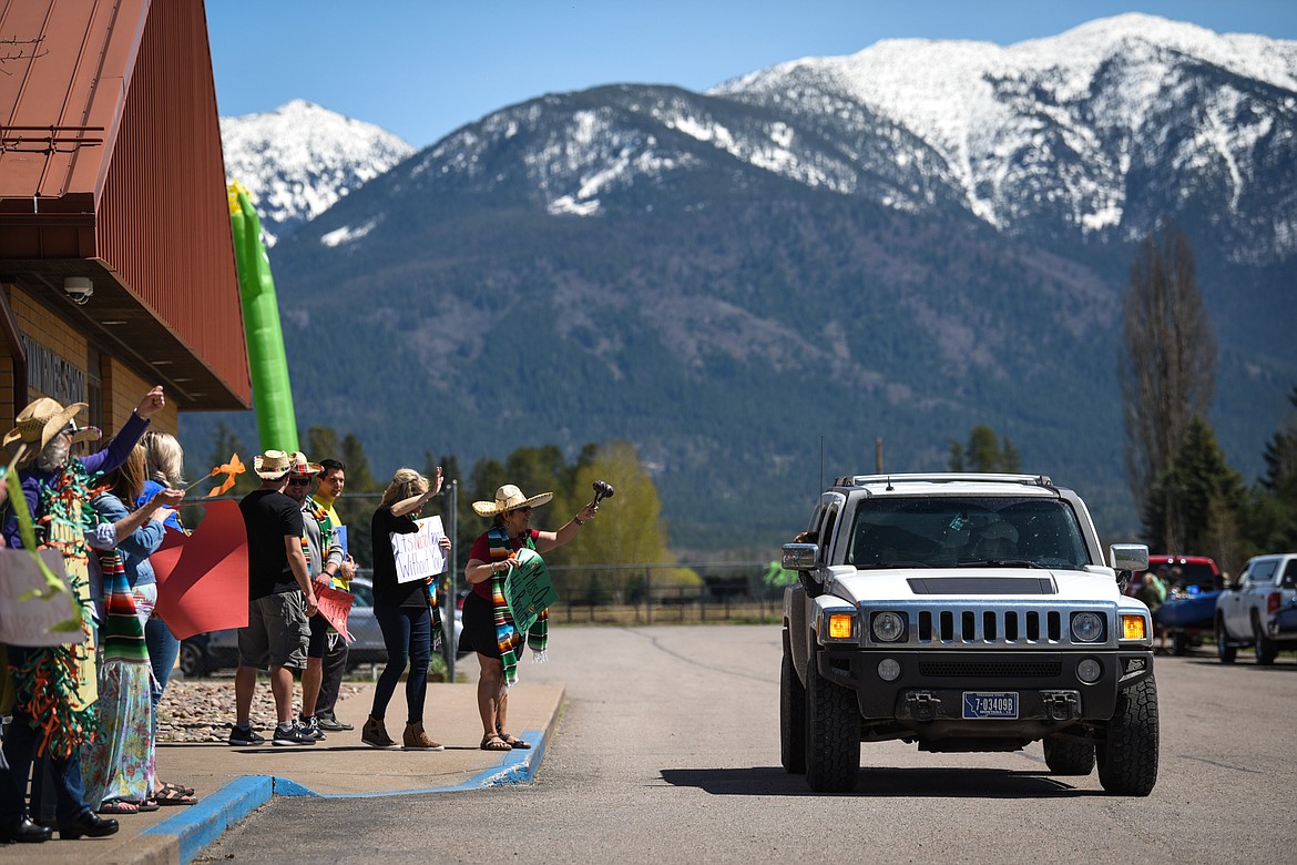 Swan River School teachers and staff wave to students and parents during a Cinco de Mayo Parade outside the school in Bigfork on Tuesday. (Casey Kreider/Daily Inter Lake)