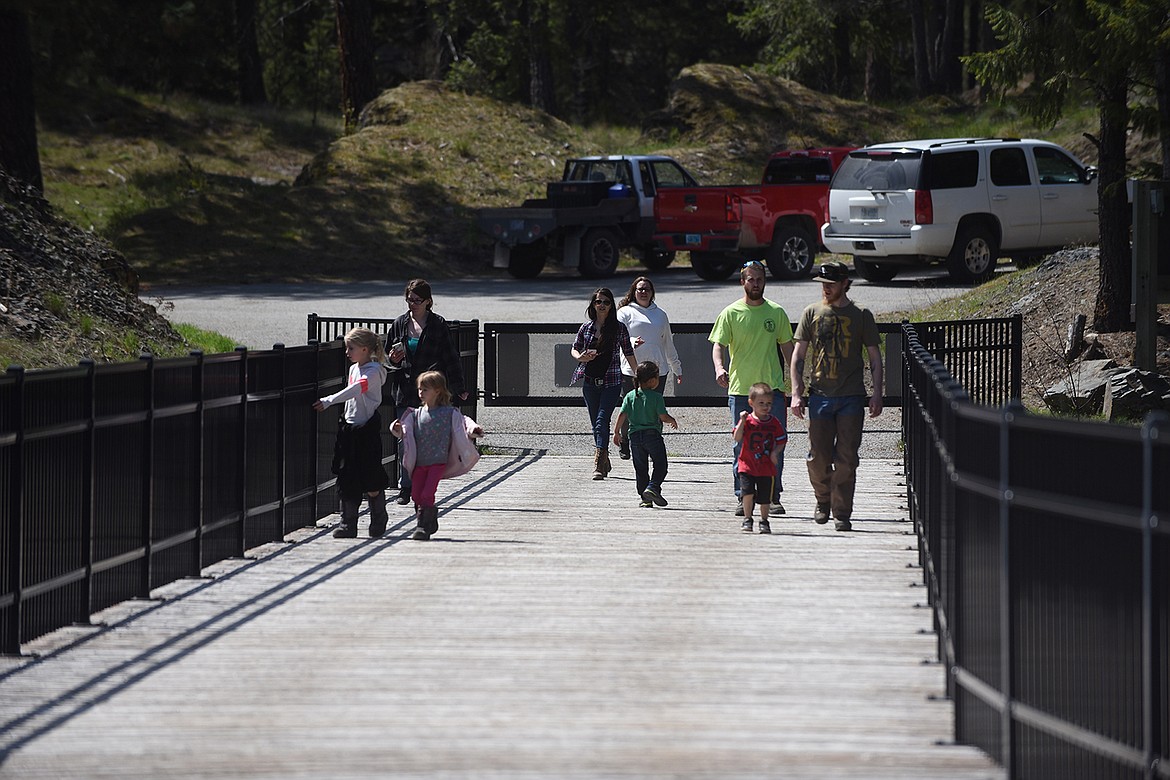 A family from Marion begins its journey across the High Bridge in Thompson Falls Sunday, April 26. The High Bridge has attracted visitors from across the U.S. and foreign countries. (Scott Shindledecker/Valley Press)