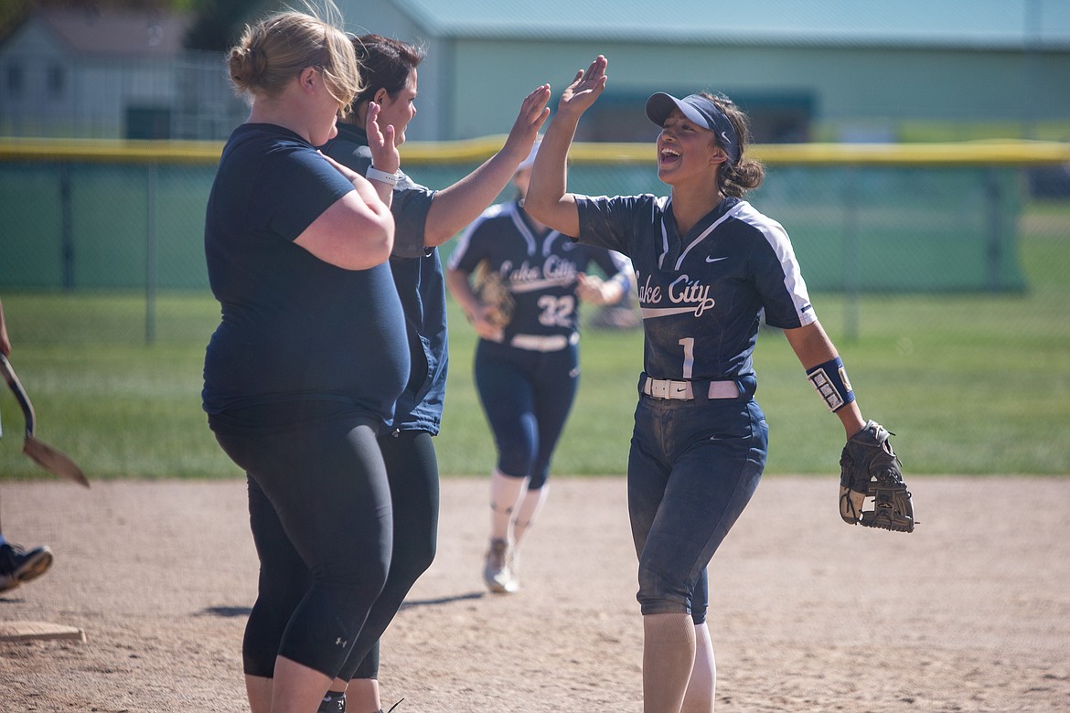 Lake City’s Ashlynn Allen gets high-fives from assistant coaches Janey Ortega, left, and Amanda Krier after the Timberwolves won the 5A Region 1 championship last season.