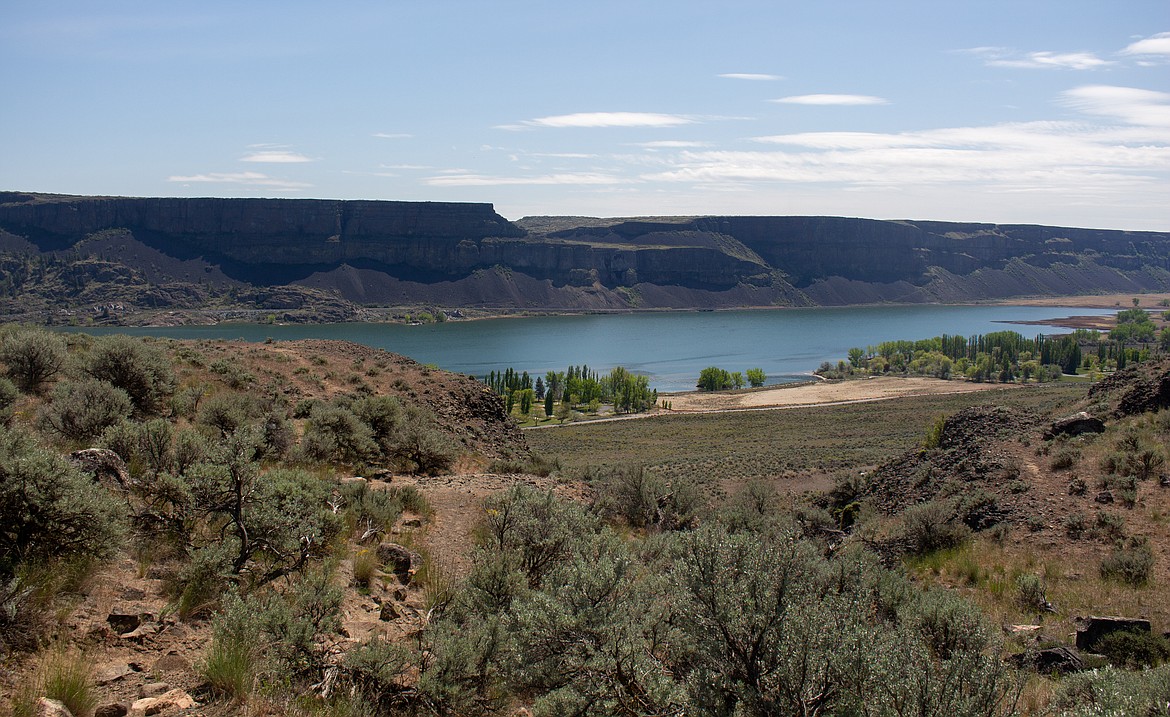 The trees on the shoreline of Devil’s Punch Bowl shrink looking down from near the top of Steamboat Rock inside the state park.