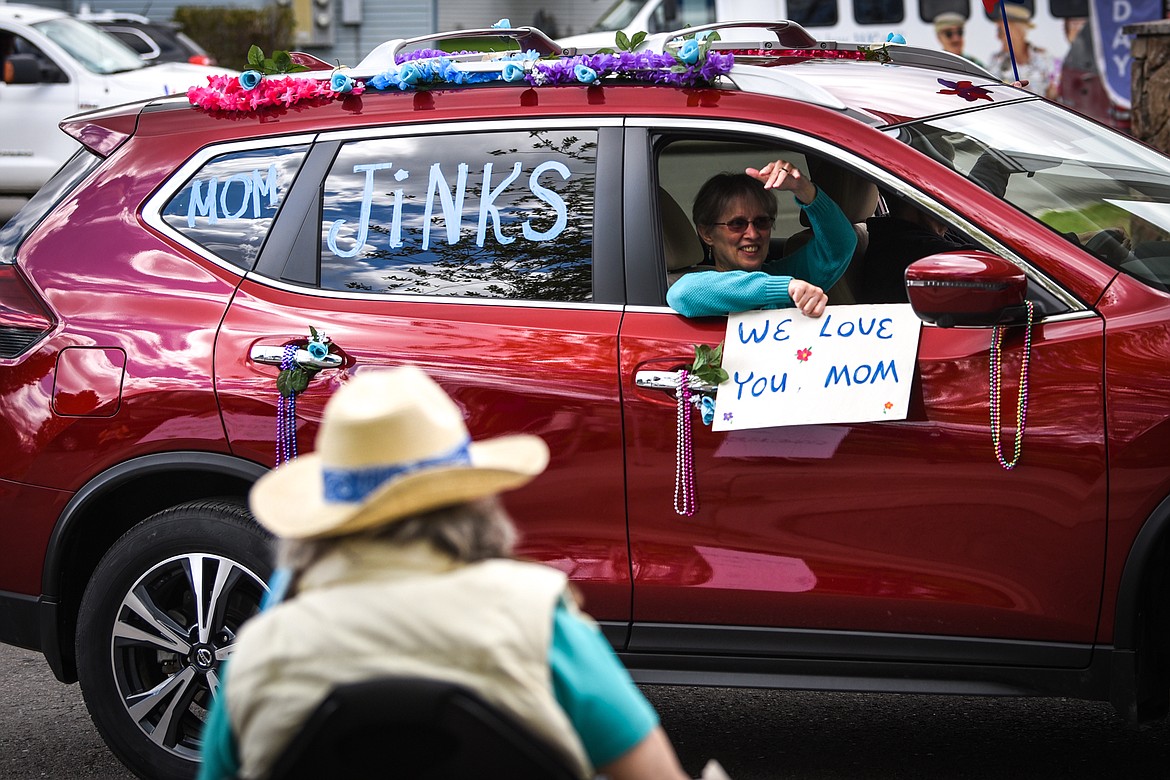 Family members wave to residents during a drive-by parade for Mother's Day at Prestige Assisted Living at Kalispell on Friday, May 8. (Casey Kreider/Daily Inter Lake)