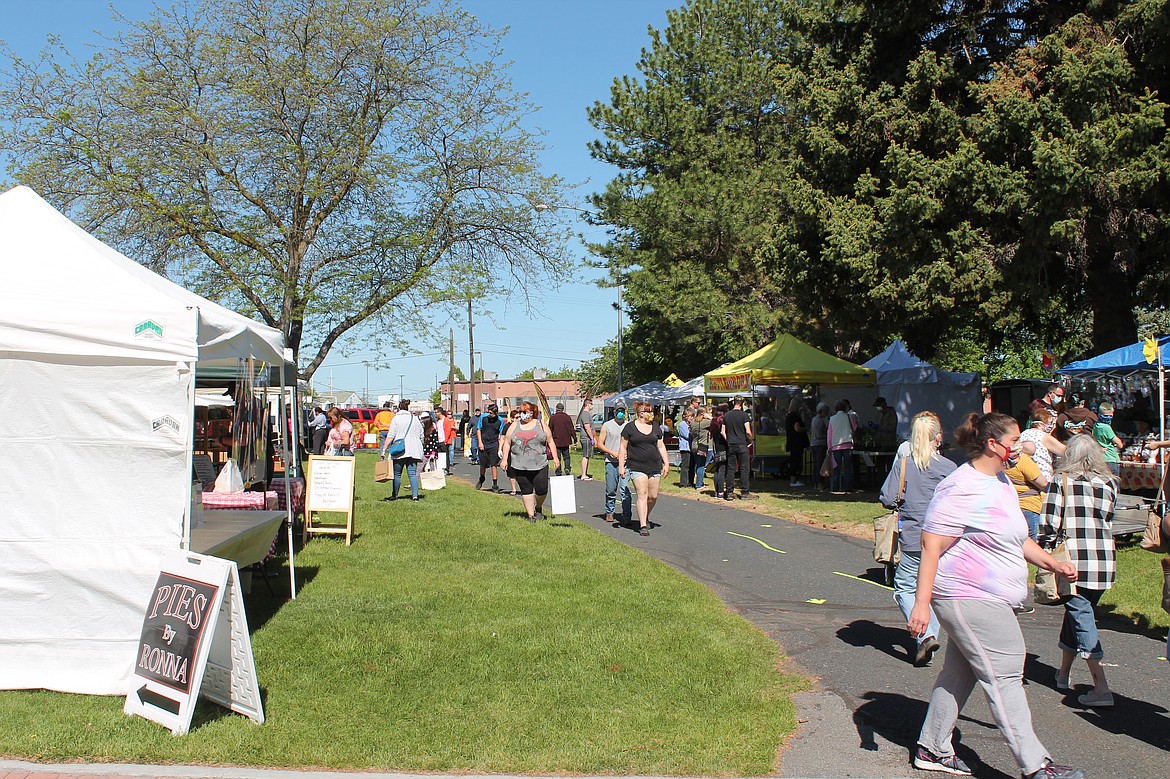 Joel Martin/Columbia Basin Herald 
 A good-sized crowd turned out – mostly masked and keeping their distance – for the Moses Lake Farmers Market opening Saturday.