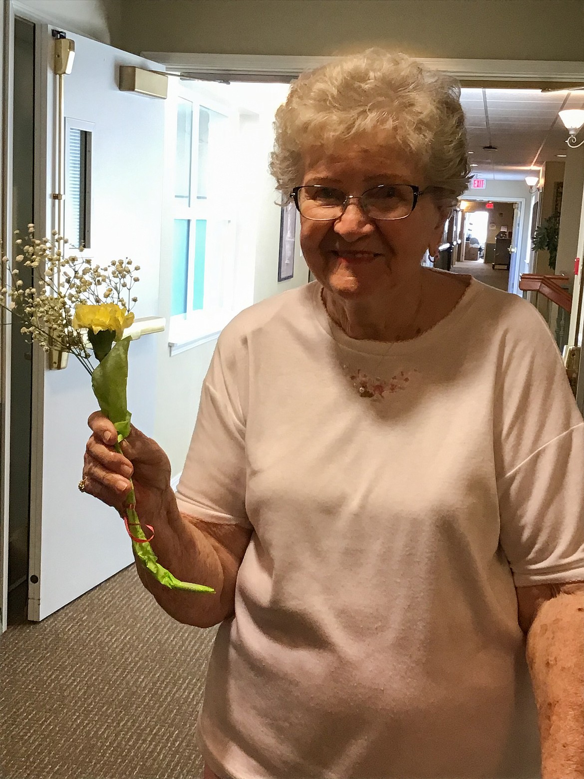 Courtesy photo 
 Yuvonne Buckley, a mother of two daughters, smiles with her Mother’s Day flowers given to her by the staff at the Avamere at Moses Lake assisted-living facility on Sunday.