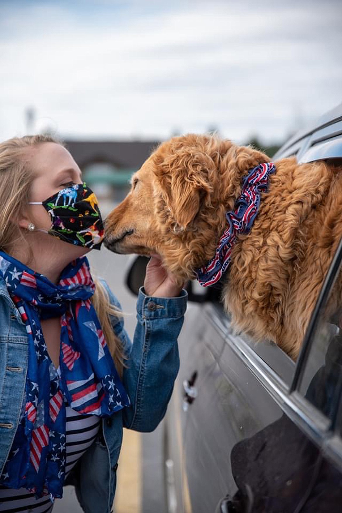 Loni Hanson says hello to dog Brosey before the start of a parade held by the Goldenstock Whitefish group to thank those on the frontline of the COVID-19 pandemic. (Photo courtesy Brian Kelley)