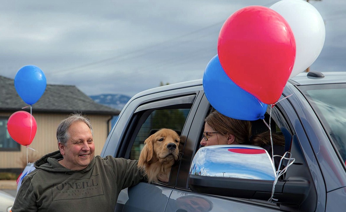 Mark Logsdon, dog Comet and Erin Moseley wait for the start of the Goldenstock Whitefish parade. (Photo courtesy Brian Kelley)