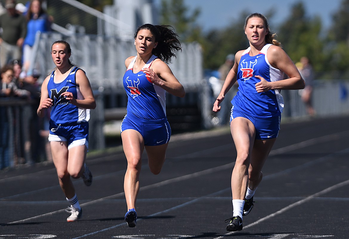 Bigfork’s Haile Norred, right, took first in the girls 100 meter dash at the Bigfork Invitational track and field meet on Saturday. (Casey Kreider/Daily Inter Lake)